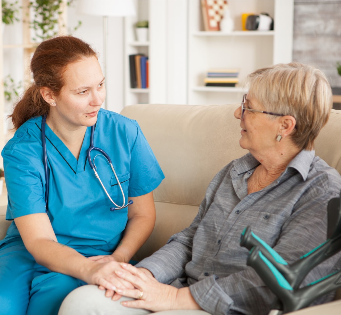 Elderly woman with a caregiver